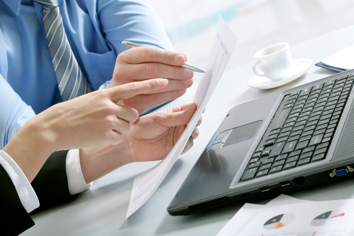 Professional reviewing application reports alongside technology